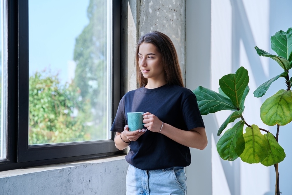 Woman inside inpatient rehab looking out of window