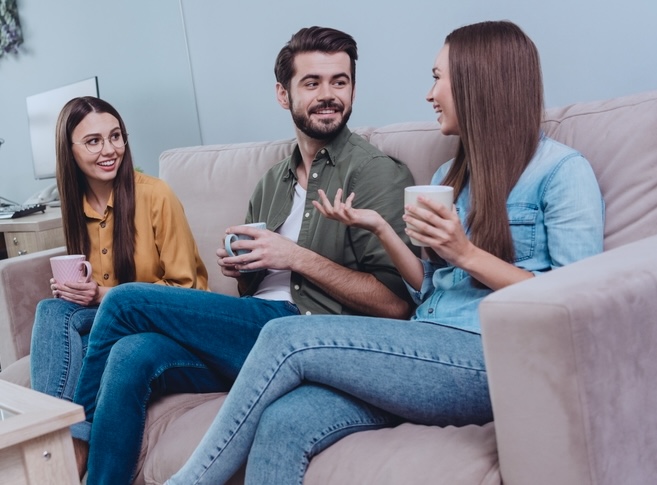 Group of residents inside an inpatient drug rehab speaking in the common living area