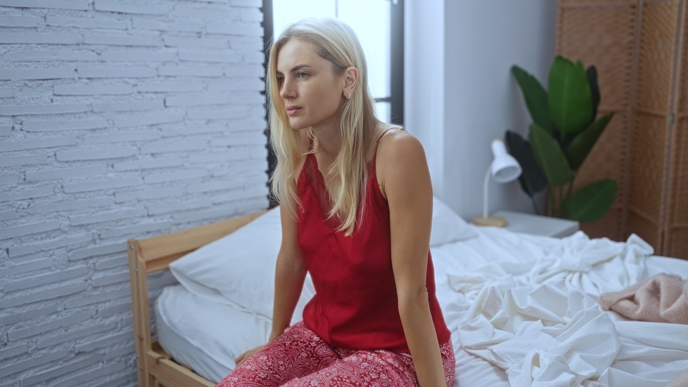Female reflecting in a private room inside an inpatient rehab