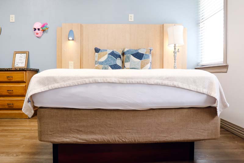 Drug Rehab Louisiana Bedroom Showing Bed, Headboard and Wall