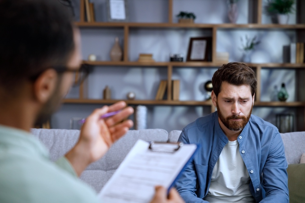 Male adult discussing his drug addiction in inpatient rehab