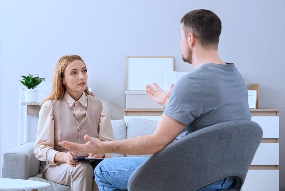 Man continuing treatment after inpatient rehab through counseling