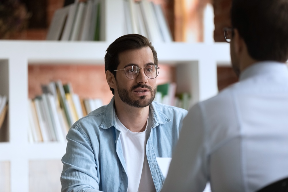 Male talking to his employer about rehab